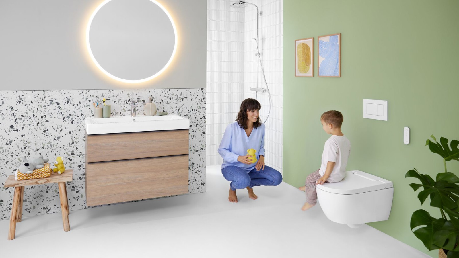 Woman and child in a colourful bathroom with Geberit Option mirror and Geberit AquaClean Alba
