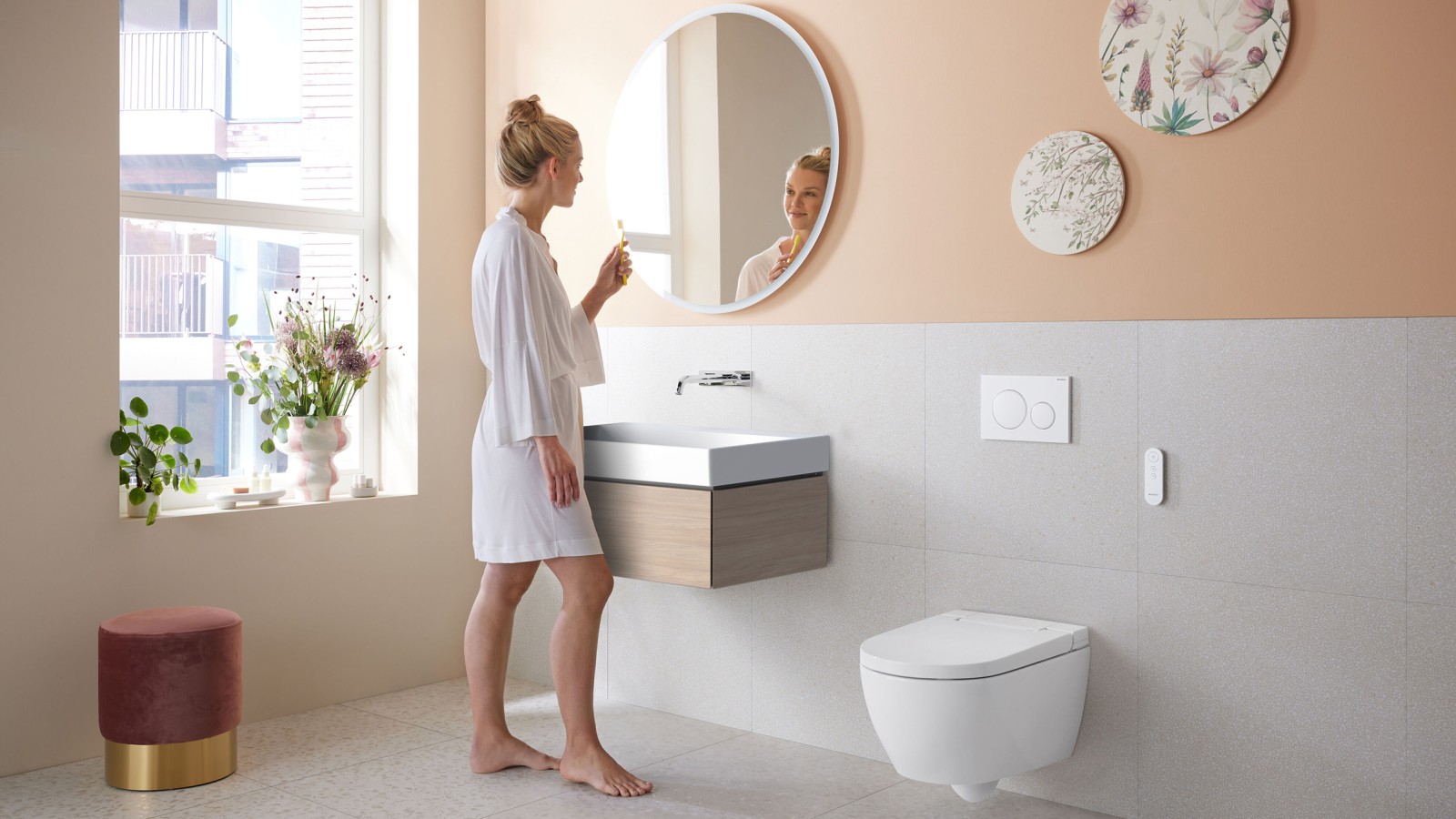Woman in bathroom with Geberit AquaClean Alba – a cost-effective bidet toilet with spray functionality