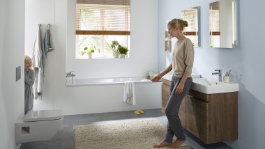 Mother and child in a family bathroom with Geberit Renova products