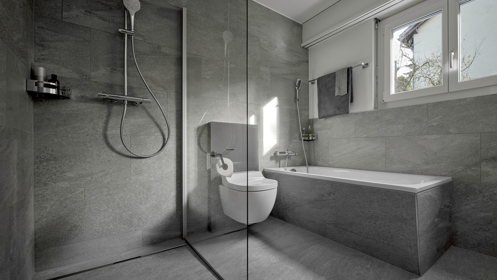 A shower toilet between a floor-standing shower and a bathtub A shower toilet between a floor-standing shower and a bathtub