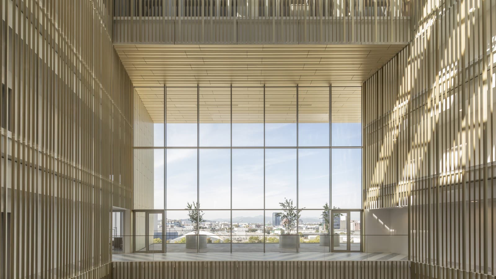 The atrium is clad with gilded anodized aluminium profiles whose tones change depending on the sun’s movements (© Ana Skobe) The atrium is clad with gilded anodized aluminium profiles whose tones change depending on the sun’s movements (© Ana Skobe)